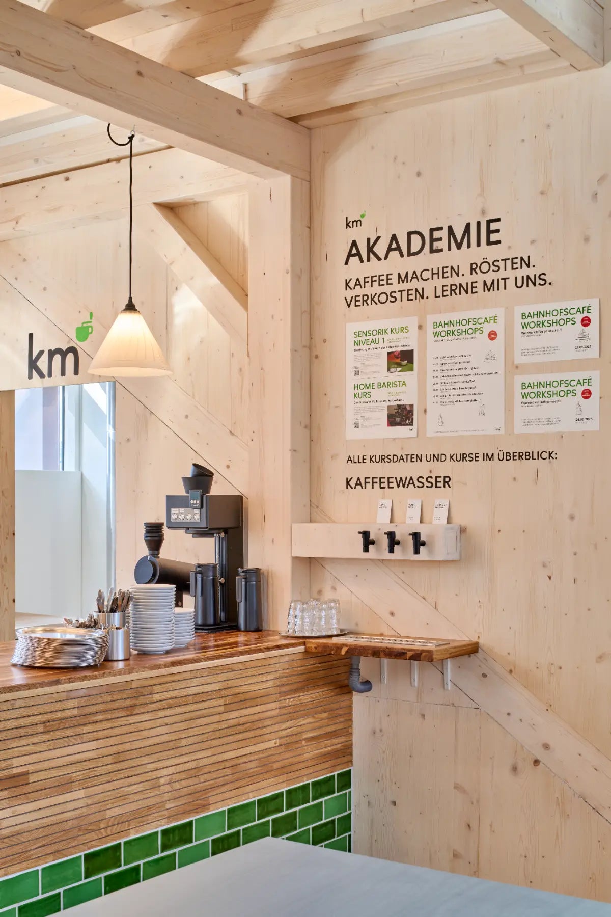 Kaffeewasser-Station und Akademie-Kursplan im KM Café Bahnhof Basel SBB