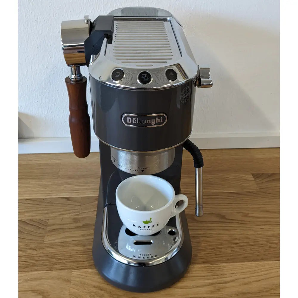 Frontansicht Delonghi mit Siebträgerhalter und Siebträger und Kaffeemacher:innen Tasse
